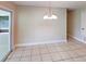 Dining room featuring modern lighting, tile flooring, and sliding glass doors at 6255 Christina Ct, Orlando, FL 32810