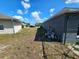 Spacious backyard showing the exterior of the home with a grassy area at 205 Golf Aire Blvd, Haines City, FL 33844