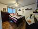 Comfortable bedroom with a queen-sized bed, hardwood floors, and plenty of natural light at 205 Golf Aire Blvd, Haines City, FL 33844