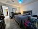 Bedroom featuring a queen bed, hardwood floors, and natural light at 205 Golf Aire Blvd, Haines City, FL 33844