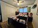 Cozy bedroom with wood floors, natural light, and neutral decor at 205 Golf Aire Blvd, Haines City, FL 33844