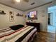 Bedroom with a queen-size bed, wood floors, and a large window for natural light at 205 Golf Aire Blvd, Haines City, FL 33844