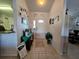 Welcoming entryway featuring tiled floors, decorative wall art, and a charming houseplant at 205 Golf Aire Blvd, Haines City, FL 33844