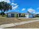 Charming single-story home with a well-manicured lawn, a two car garage, and a nicely painted exterior at 205 Golf Aire Blvd, Haines City, FL 33844