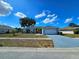 Charming single-story home with a well-manicured lawn, a two car garage, and a nicely painted exterior at 205 Golf Aire Blvd, Haines City, FL 33844