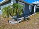 Well-maintained front yard landscaping with decorative rock and palm trees at 205 Golf Aire Blvd, Haines City, FL 33844
