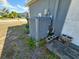 Exterior view of modern HVAC unit with concrete block stands on the side of the home at 205 Golf Aire Blvd, Haines City, FL 33844