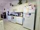 Bright kitchen with ample storage cabinets, white appliances, and tile flooring at 205 Golf Aire Blvd, Haines City, FL 33844