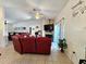 Spacious living room featuring a fireplace, tile floors, and sliding glass doors to the lanai at 205 Golf Aire Blvd, Haines City, FL 33844