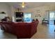 Spacious living room featuring a fireplace, tile floors, and sliding glass doors to the lanai at 205 Golf Aire Blvd, Haines City, FL 33844