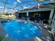 Inviting pool area featuring a screened enclosure and ample seating for relaxation at 205 Golf Aire Blvd, Haines City, FL 33844