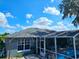 View of the screened-in pool and lanai in the backyard at 205 Golf Aire Blvd, Haines City, FL 33844