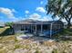 View of screened in pool and lanai in backyard of home at 205 Golf Aire Blvd, Haines City, FL 33844
