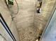 Modern tiled shower with niche, shower caddy and mosaic floor at 205 Golf Aire Blvd, Haines City, FL 33844