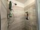 Modern tiled shower with niche and shower caddy at 205 Golf Aire Blvd, Haines City, FL 33844