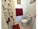 Cozy bathroom featuring tiled floors, neutral walls and butterfly-themed decor at 205 Golf Aire Blvd, Haines City, FL 33844