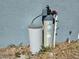 Water filter and additional components attached to the side of the house at 205 Golf Aire Blvd, Haines City, FL 33844