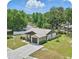 Aerial view of a well-maintained home featuring a spacious lawn and a convenient two-car garage at 2271 Crystal Grove Ln, Lakeland, FL 33801
