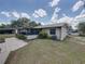 Home showcasing a screened patio, a well-kept lawn, and mature landscaping at 2271 Crystal Grove Ln, Lakeland, FL 33801