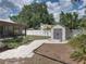 Backyard boasts a screened enclosure, storage shed, and manicured walkway at 2271 Crystal Grove Ln, Lakeland, FL 33801