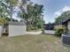 Backyard showcases a storage shed, screened enclosure and verdant lawn at 2271 Crystal Grove Ln, Lakeland, FL 33801