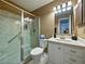 Neutral bathroom featuring a glass enclosed shower with a handheld sprayer and a white vanity with a sink at 2271 Crystal Grove Ln, Lakeland, FL 33801