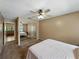 Bedroom featuring carpet, ceiling fan, and a large mirrored closet at 2271 Crystal Grove Ln, Lakeland, FL 33801