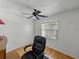 Bedroom featuring hardwood floors, ceiling fan, and a large window, all with bright, light walls at 2271 Crystal Grove Ln, Lakeland, FL 33801