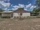 Exterior shot features a low-lying home surrounded by manicured hedges at 2271 Crystal Grove Ln, Lakeland, FL 33801