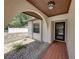 Inviting front entrance with tiled walkway, stucco walls, and an arched entryway at 2271 Crystal Grove Ln, Lakeland, FL 33801