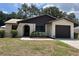 Charming single-story home with a well-maintained lawn and attached garage at 2271 Crystal Grove Ln, Lakeland, FL 33801