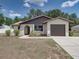 Inviting single-story home with an attached garage and beautifully landscaped front yard at 2271 Crystal Grove Ln, Lakeland, FL 33801
