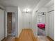 Bright hallway with hardwood floors, closet, and views into the adjacent bedrooms at 2271 Crystal Grove Ln, Lakeland, FL 33801