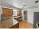 Updated kitchen with stainless steel appliances, wood cabinets, granite countertops, and hardwood floors at 2271 Crystal Grove Ln, Lakeland, FL 33801
