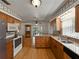 The kitchen features stainless steel appliances, wood cabinets, granite countertops, a sink, and hardwood floors at 2271 Crystal Grove Ln, Lakeland, FL 33801