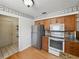 This updated kitchen features stainless steel appliances, wood cabinets, granite countertops, and hardwood floors at 2271 Crystal Grove Ln, Lakeland, FL 33801