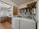 The laundry room is adjacent to the kitchen and features a washing machine and dryer at 2271 Crystal Grove Ln, Lakeland, FL 33801
