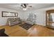 Bright living room featuring hardwood floors, a large mirror, and comfortable seating at 2271 Crystal Grove Ln, Lakeland, FL 33801