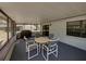 Enclosed back porch with table and chairs, plus ample view of the backyard at 2271 Crystal Grove Ln, Lakeland, FL 33801