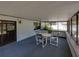Enclosed back porch with table and chairs, plus ample view of the backyard at 2271 Crystal Grove Ln, Lakeland, FL 33801