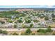Overhead shot showing an array of homes with pools and screened enclosures in a lush community at 2806 Spinning Silk Ct, Kissimmee, FL 34747