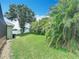 Spacious backyard with mature trees and lush green grass at 2806 Spinning Silk Ct, Kissimmee, FL 34747