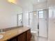 Bright bathroom with granite countertop, walk-in shower, and a combined toilet/bidet at 2806 Spinning Silk Ct, Kissimmee, FL 34747