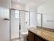 Bathroom featuring granite countertop, glass-enclosed shower, and tile flooring at 2806 Spinning Silk Ct, Kissimmee, FL 34747