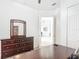 This bedroom features a full dresser with a mirror and a partially-viewable connected room at 2806 Spinning Silk Ct, Kissimmee, FL 34747
