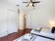 Bedroom with ceiling fan, hardwood floors, and closet at 2806 Spinning Silk Ct, Kissimmee, FL 34747