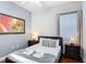 Cozy bedroom featuring a comfortable bed, nightstands, modern art, and bright lighting at 2806 Spinning Silk Ct, Kissimmee, FL 34747
