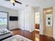 Bedroom with hardwood floors, TV, closet, and an ensuite bathroom at 2806 Spinning Silk Ct, Kissimmee, FL 34747