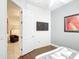 Cozy bedroom with tiled floors, a modern fan, wall-mounted TV, and comfortable leather chair at 2806 Spinning Silk Ct, Kissimmee, FL 34747