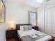 Comfortable bedroom with a ceiling fan, window, and a closet with bright light at 2806 Spinning Silk Ct, Kissimmee, FL 34747